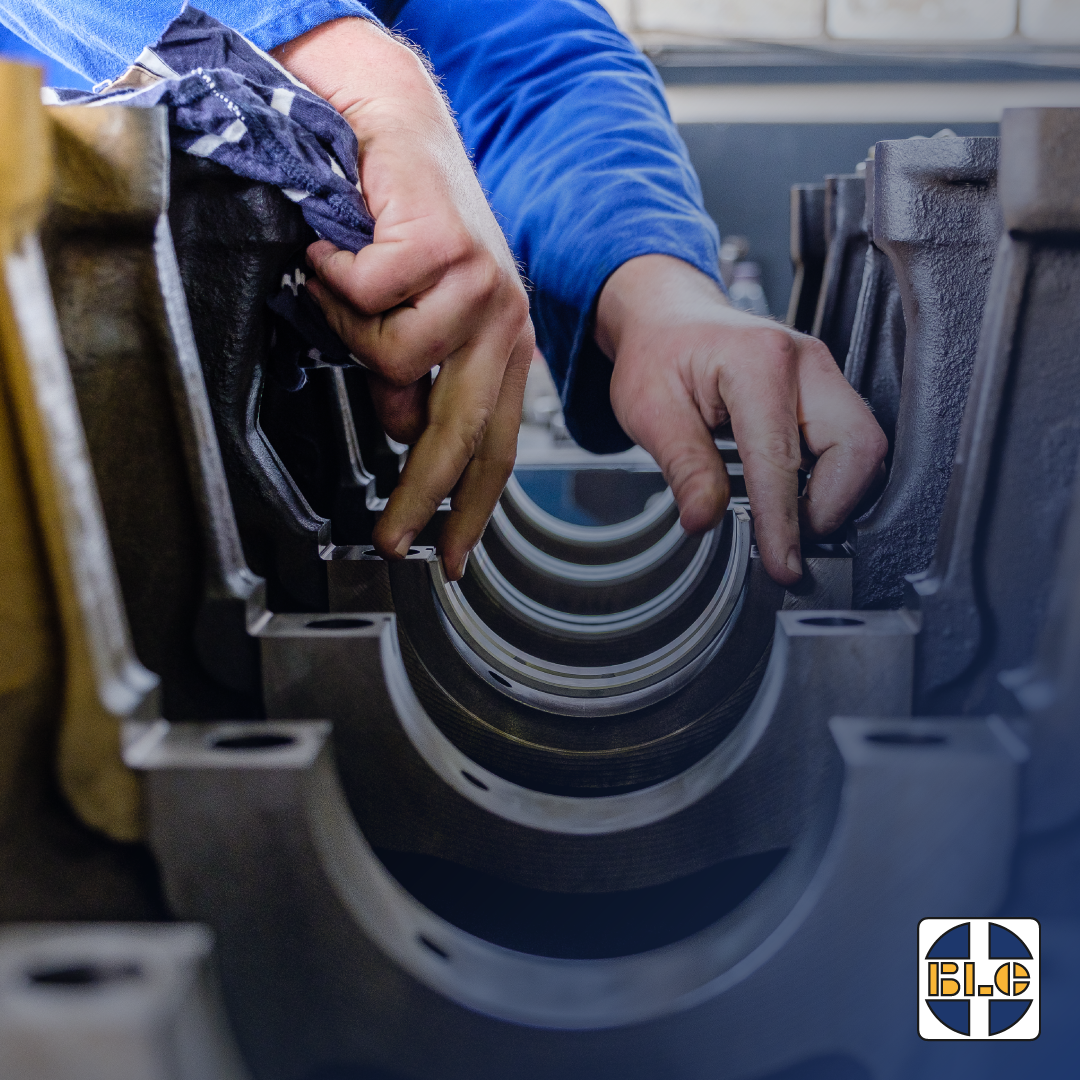 Technician inspecting a heavy equipment component during repair or rebuild work at BLC Plant